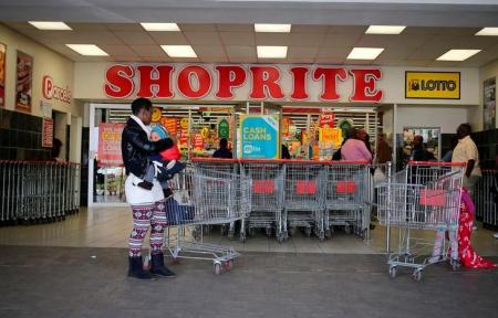 A shopper is seen outside a Shoprite store in Johannesburg July 7, 2015.  REUTERS/Siphiwe Sibeko/File Photo