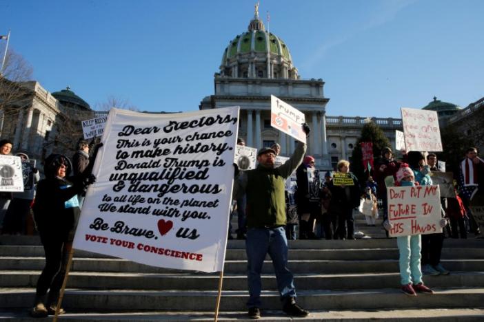 People protest against U.S. President-elect Donald Trump as electors gather to cast their votes for U.S. president at the Pennsylvania State Capitol in Harrisburg, Pennsylvania, U.S. December 19, 2016. REUTERS/Jonathan Ernst