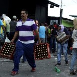 People carry goods taken from a food wholesaler after it was broken into, in La Fria, Venezuela December 17, 2016. REUTERS/Carlos Eduardo Ramirez