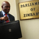 (161209) -- HARARE, Dec. 9, 2016 (Xinhua) -- Zimbabwean Finance Minister Patrick Chinamasa displays the budget briefcase containing the 2017 National Budget in Harare, capital of Zimbabwe, Dec. 8, 2017. Zimbabwe's economy is projected to grow by a modest 0.6 percent in 2016, down from 1.1 percent in 2015 due to an El-Nino induced drought and weak commodity prices on the international market, Finance Minister Patrick Chinamasa said on Thursday. (Xinhua)