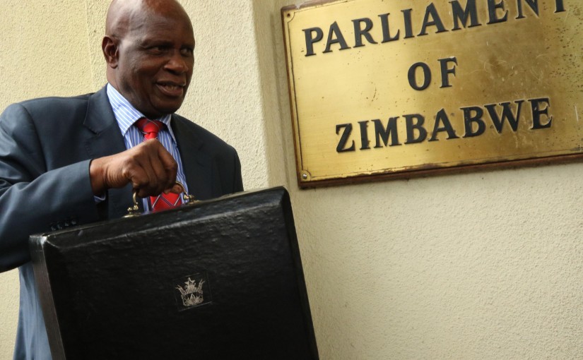 (161209) -- HARARE, Dec. 9, 2016 (Xinhua) -- Zimbabwean Finance Minister Patrick Chinamasa displays the budget briefcase containing the 2017 National Budget in Harare, capital of Zimbabwe, Dec. 8, 2017. Zimbabwe's economy is projected to grow by a modest 0.6 percent in 2016, down from 1.1 percent in 2015 due to an El-Nino induced drought and weak commodity prices on the international market, Finance Minister Patrick Chinamasa said on Thursday. (Xinhua)