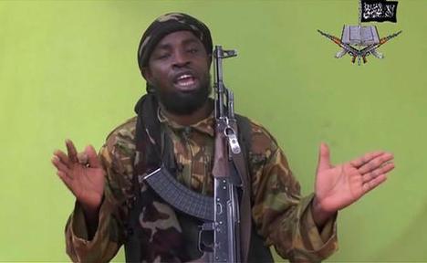 FILE - In this Monday May 12, 2014 file photo taken from video by Nigeria's Boko Haram terrorist network, shows their leader Abubakar Shekau speaking to the camera. Boko Haram's leader  Abubakar Shekau urges his fighters to "kill, slaughter and abduct and detonate bombs everywhere," in a new video that denies Nigerian government claims that his Islamic extremist group has been crushed. (AP Photo/File)