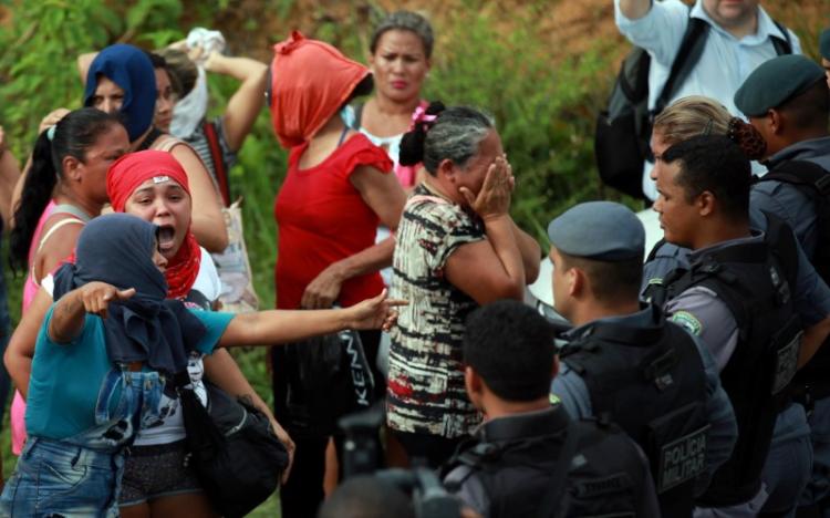 Relatives of prisoners react near riot police at a checkpoint close to the prison where around 60 people were killed in a prison riot in the Amazon jungle city of Manaus, Brazil, January 2, 2017. REUTERS/Michael Dantas