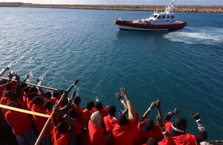 Migrants celebrate on board the former fishing trawler Golfo Azzurro as they arrive at the port of Pozzallo in Sicily, two days after they were rescued by the Spanish NGO Proactiva Open Arms after the raft they were on drifted out of control in the central Mediterranean Sea, January 4, 2017.  REUTERS/Yannis Behrakis