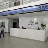 People walk near the reception at the Johannesburg Stock Exchange (JSE) in Sandton, Johannesburg, South Africa December 10, 2015. REUTERS/Siphiwe Sibeko