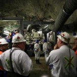 Mine workers are seen in front of a giant drill-cum-vacuum cleaner that accelerates drilling at an underground tunnel at Cullinan mine outside Pretoria, northeast of Johannesburg, February 2, 2017. REUTERS/Siphiwe Sibeko