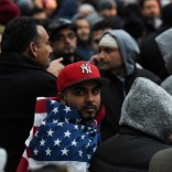 Mohammed Abdul wraps himself in an American flag before a prayer session during a protest by the Yemeni community against U.S. President Donald Trump's travel ban in the Brooklyn borough of New York City, U.S. February 2, 2017. REUTERS/Stephanie Keith