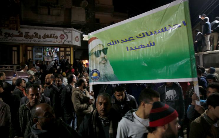Relatives, studients and friends of Omar Abdel-Rahman, the Muslim cleric known as "The Blind Sheik" who was convicted of conspiracy in the 1993 World Trade Center bombing in New York, shout solgans and hold a banner with his picture reading "A martyr to God" after the funeral outside the Grand Mosque at El Gamalia village in Mansoura city northo of in Cairo, Egypt February 22, 2017. REUTERS/Amr Abdallah Dalsh