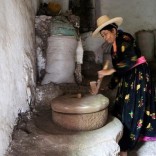 A woman uses a stone grinder to make flour in her house in the mountains, in the Jafariya district of the western province of Raymah, Yemen May 21, 2016. REUTERS/Abduljabbar Zeyad