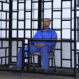Saif al-Islam Gaddafi, son of late Libyan leader Muammar Gaddafi, attends a hearing behind bars in a courtroom in Zintan May 25, 2014. REUTERS/Stringer