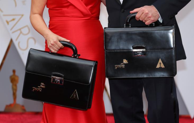Oscar winning ballots are carried along the red carpet by personnel from Price Waterhouse Coopers as they arrive for the  89th Academy Awards in Hollywood, California, U.S. February 26, 2017. REUTERS/Mike Blake