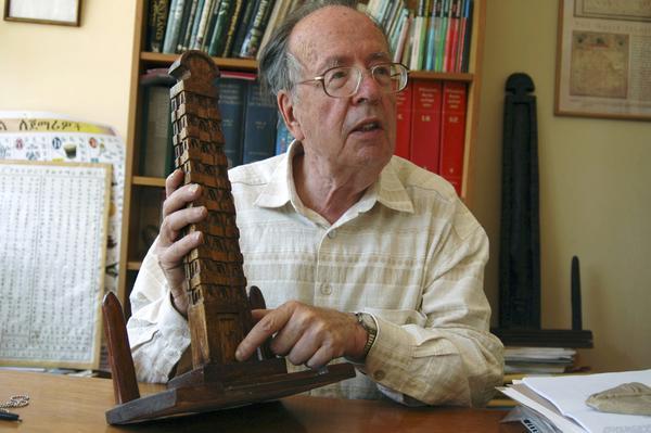 Historian and campaigner Richard Pankhurst points at a model of the Axum obelisk in his study in Addis Ababa, Ethiopia, April 5, 2005. Photograph taken April 5, 2005. REUTERS/Andrew Heavens