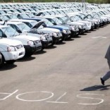 A worker walks near a row of cars at Nissan's manufacturing plant in Rosslyn, outside Pretoria,  file.   REUTERS/Siphiwe Sibeko/File Photo