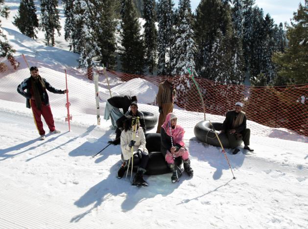 Customers and inner tube renters rest on the side of the piste at the ski resort in Malam Jabba, Pakistan February 7, 2017. REUTERS/Caren Firouz