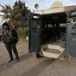 A rebel fighter stands with his weapon near a military vehicle on the outskirts of the northern Syrian town of al-Bab, Syria February 8, 2017. REUTERS/Khalil Ashawi
