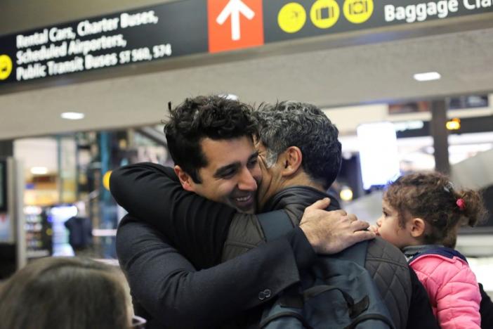 Iranian citizen and U.S green card holder Cyrus Khosravi (L) greets his brother, Hamidreza Khosravi (C), and niece, Dena Khosravi (R), 2, after they were detained for additional screening following their arrival to Seattle-Tacoma International Airport to visit Cyrus, during a pause in U.S. President Donald Trump's travel ban in SeaTac, Washington, U.S. February 6, 2017.  REUTERS/David Ryder