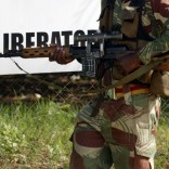 An armed member of the Zimbabwe National Army provides security for the proceedings on the second and final day of the Zanu pf National Peoples Conference in Goromonzi, 45 kilometres east of Harare, Saturday, Dec, 16, 2006.  During the conference Zimbabwe President Mugabe has called for unity in the troubled southern African nation which is facing its worst economic crisis since independence from Britain in 1980, and attacked western countries. (AP PHOTO/Tsvangirayi Mukwazhi)