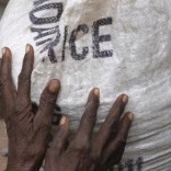 A newly arrived Somali refugee holds her bag of relief maize outside a distribution centre at the Dadaab refugee camp, near the Kenya-Somalia, July 23, 2011. REUTERS/Barry Malone