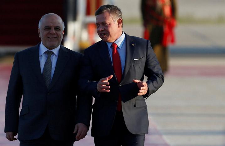 Jordan's King Abdullah II welcomes Iraqi Prime Minister Haider al-Abadi during a reception ceremony at the Queen Alia International Airport in Amman, Jordan March 28, 2017. REUTERS/Muhammad Hamed