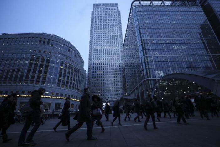 Workers walk to work during the morning rush hour in the financial district of Canary Wharf in London, Britain, January 26, 2017.  REUTERS/Eddie Keogh