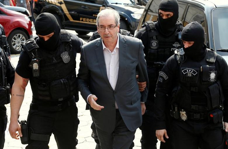 FILE PHOTO - Former speaker of Brazil's Lower House of Congress, Eduardo Cunha (C), is escorted by federal police officers as he arrives to the Institute of Forensic Science in Curitiba, Brazil, October 20, 2016. REUTERS/Rodolfo Buhrer/File Photo