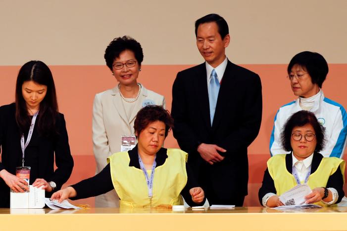 Carrie Lam (2nd L) smiles as officials count votes during the election for Hong Kong's next Chief Executive in Hong Kong, China, March 26, 2017.   REUTERS/Bobby Yip