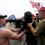 A pro-Trump rally participant is punched in the face by an anti-Trump protester as the two sides clash at a Pro-Trump rally in Huntington Beach, California, U.S., March 25, 2017.    REUTERS/Patrick T. Fallon
