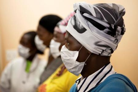 Patients with HIV and tuberculosis (TB) wear masks while awaiting consultation at a clinic in Cape Town's Khayelitsha township, In South Africa, February 23, 2010. REUTERS/Finbarr O'Reilly/File Photo