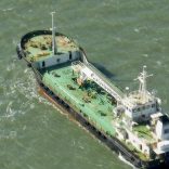 In this photo taken Monday, Oct. 27, 2014, the Aris 13 oil tanker is seen from a helicopter in the harbor of Gladstone, Australia. Pirates have hijacked the Aris 13 oil tanker off the coast of Somalia, officials and piracy experts said Tuesday, March 14, 2017, the first such seizure of a large commercial vessel on the crucial global trade route since 2012. (Kevin Finnigan/Tropic Maritime Images via AP)