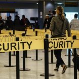 Passengers make their way in a security checkpoint at the International JFK airport in New York October 11, 2014. REUTERS/Eduardo Munoz
