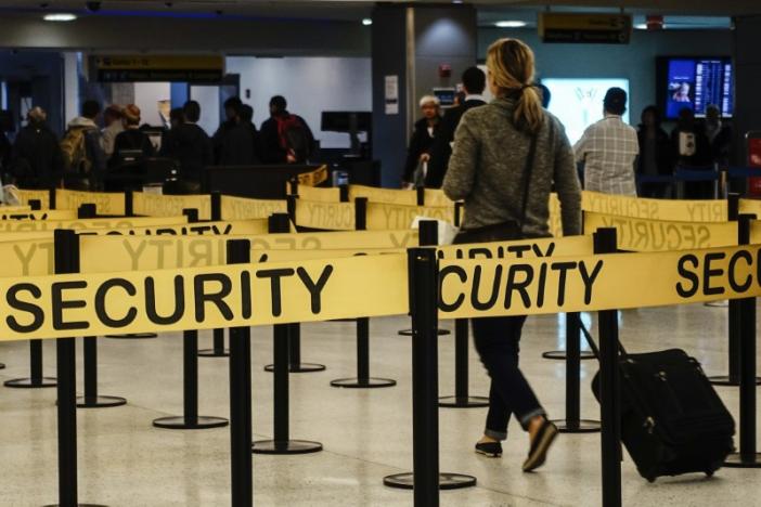Passengers make their way in a security checkpoint at the International JFK airport in New York October 11, 2014. REUTERS/Eduardo Munoz