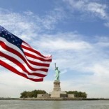 An U.S. flag waves in the wind on a boat near the Statue of Liberty in New York August 31, 2011.  REUTERS/Lucas Jackson