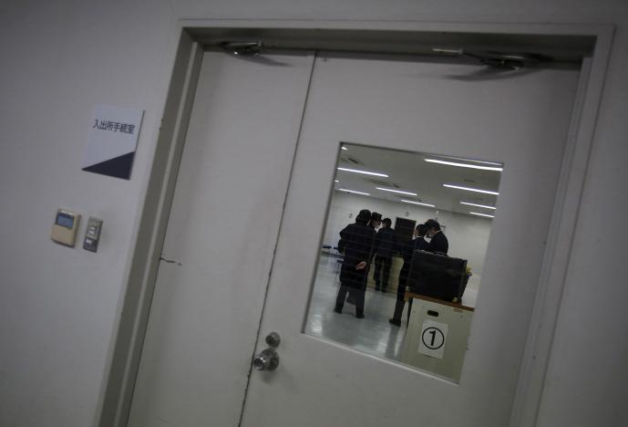FILE PHOTO: Guards at the East Japan Immigration Center stand inside a processing room at the center in Ushiku, Ibaraki prefecture, Japan, March 19, 2015. REUTERS/Yuya Shino/File Photo