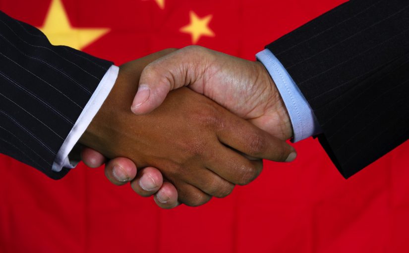 Business team shaking hands in front of the flag
