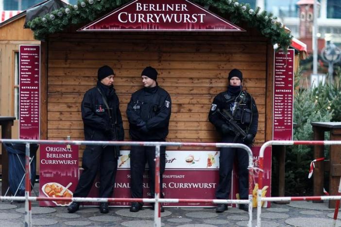 FILE PHOTO: Police stand guard at the Kaiser-Wilhelm-Gedaechtniskirche Christmas market in Berlin, Germany, December 21, 2016, after a truck ploughed through a crowd at the Breitscheid square Christmas market.     REUTERS/Hannibal Hanschke/File Photo - RTS12FEB