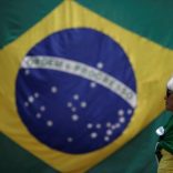 A woman is seen with a Brazilian flag in front of the National Congress during a protest against corruption, in Brasilia, Brazil March 26, 2017. REUTERS/Ueslei Marcelino