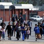 REFILE -- CORRECTING TYPO --      Students who were evacuated after a shooting at North Park Elementary School walk with their waiting parents at a high school in San Bernardino, California, U.S. April 10, 2017.  REUTERS/Mario Anzuoni