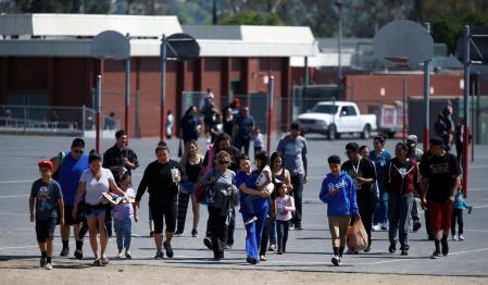 REFILE -- CORRECTING TYPO --      Students who were evacuated after a shooting at North Park Elementary School walk with their waiting parents at a high school in San Bernardino, California, U.S. April 10, 2017.  REUTERS/Mario Anzuoni