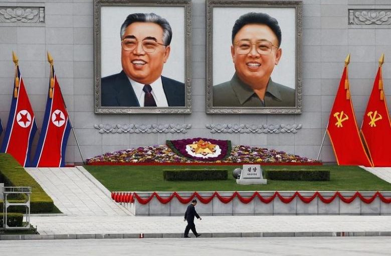 A man walks in front of portraits of North Korea founder Kim Il Sung and late leader Kim Jong Il in central Pyongyang, North Korea April 16, 2017.    REUTERS/Damir Sagolj