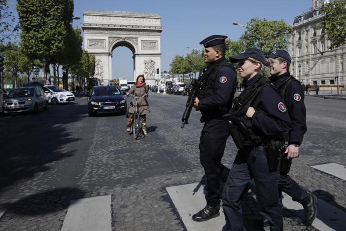 Armed French police patrol the Champs Elysees Avenue the day after a policeman was killed and two others were wounded in a shooting incident in Paris, France, April 21, 2017. REUTERS/Benoit Tessier