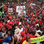 Protesters hold placards as they gather in South Africa's capital to protest against President Jacob Zuma in Pretoria, South Africa, April 12 ,2017. REUTERS/Siphiwe Sibeko