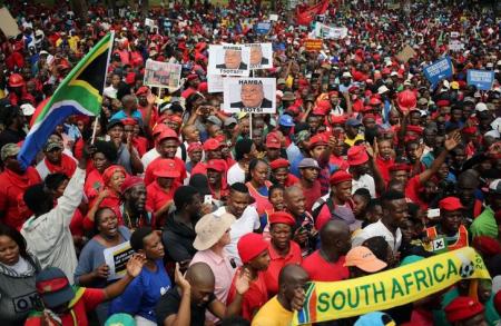 Protesters hold placards as they gather in South Africa's capital to protest against President Jacob Zuma in Pretoria, South Africa, April 12 ,2017. REUTERS/Siphiwe Sibeko