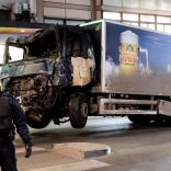 Tow trucks pull away the beer truck that crashed into the department store Ahlens after plowing down the Drottninggatan Street in central Stockholm, Sweden, April 8, 2017. Maja Suslin/TT News Agency/via Reuters