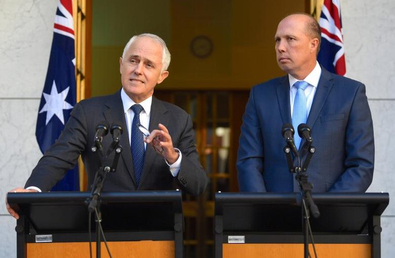 Australia's Prime Minister Malcolm Turnbull speaks as Immigration Minister Peter Dutton listens on during a media conference at Parliament House in Canberra, Australia, April 18, 2017.    AAP/Lukas Coch/via REUTERS