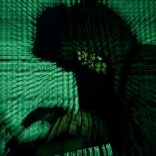 A man holds a laptop computer as cyber code is projected on him in this illustration picture taken on May 13, 2017. REUTERS/Kacper Pempel/Illustration