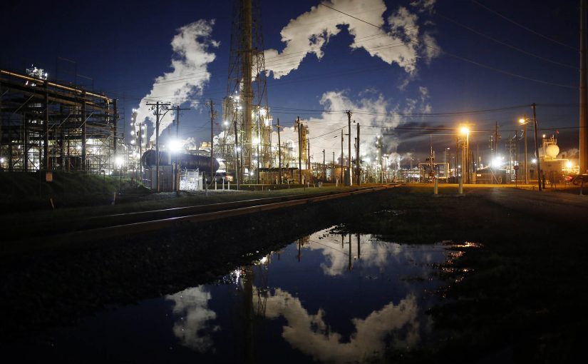Emissions from an oil refinery are reflected in a street puddle at dusk in Texas City, Texas, U.S., on Thursday, Feb. 16, 2017. Asia's energy importers will benefit from more opportunities for arbitrage, supply diversification if U.S. President Donald Trump's pro-energy policies drive meaningful upsurge in U.S. crude, LNG exports, BMI Research reports. Photographer: Luke Sharrett/Bloomberg