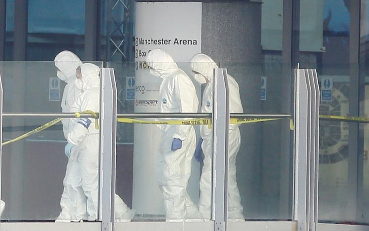 Forensics investigators work at the entrance of the Manchester Arena, Britain May 23, 2017. REUTERS/Andrew Yates