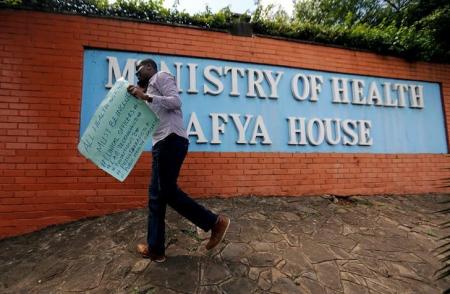 A Kenyan talks on his mobile phone outside the Ministry of Health headquarters in Nairobi, Kenya December 8, 2016. REUTERS/Thomas Mukoya