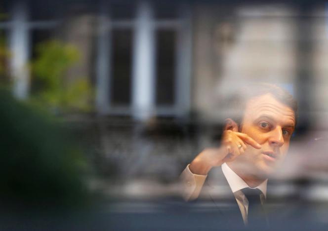 Emmanuel Macron, head of the political movement En Marche !, or Onwards !, and candidate for the 2017 presidential election, is pictured through a window of his hotel during a campaign visit in Rodez, France, May 5, 2017. REUTERS/Regis Duvignau