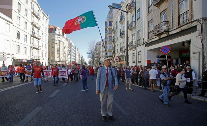 A man holds a Portuguese flag and shout slogans during a May Day march by the Portuguese union CGTP in Lisbon, Portugal, May 1, 2016. REUTERS/Hugo Correia